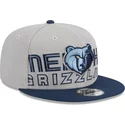 new-era-flat-brim-9fifty-draft-edition-2023-memphis-grizzlies-nba-grey-and-navy-blue-snapback-cap